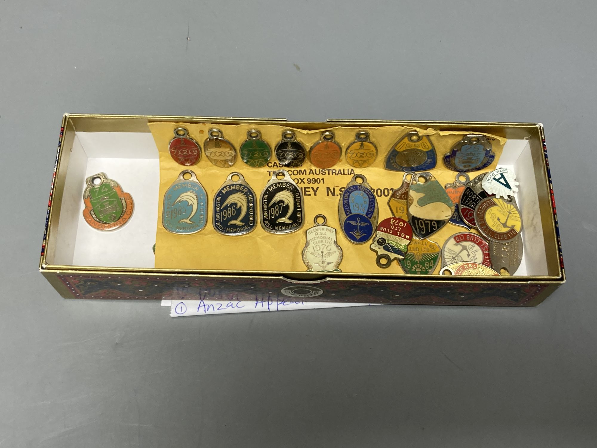 A collection of assorted enamel badges and nursing badges